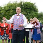 Musical director Terry Pearce leads the community sing-along at the Drayton Jubilee Concert