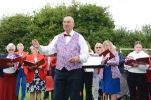 Musical director Terry Pearce leads the community sing-along at the Drayton Jubilee Concert